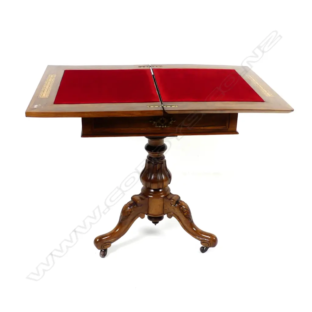 A Victorian walnut games table Image 1++