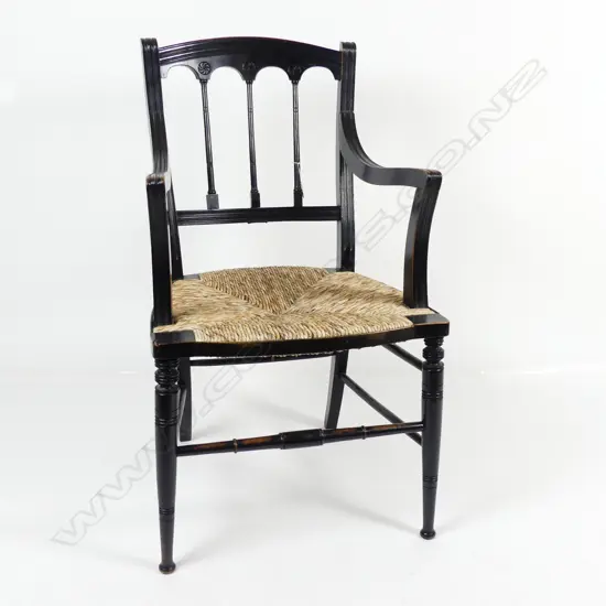 An Edwardian Arts and Crafts open elbow chair