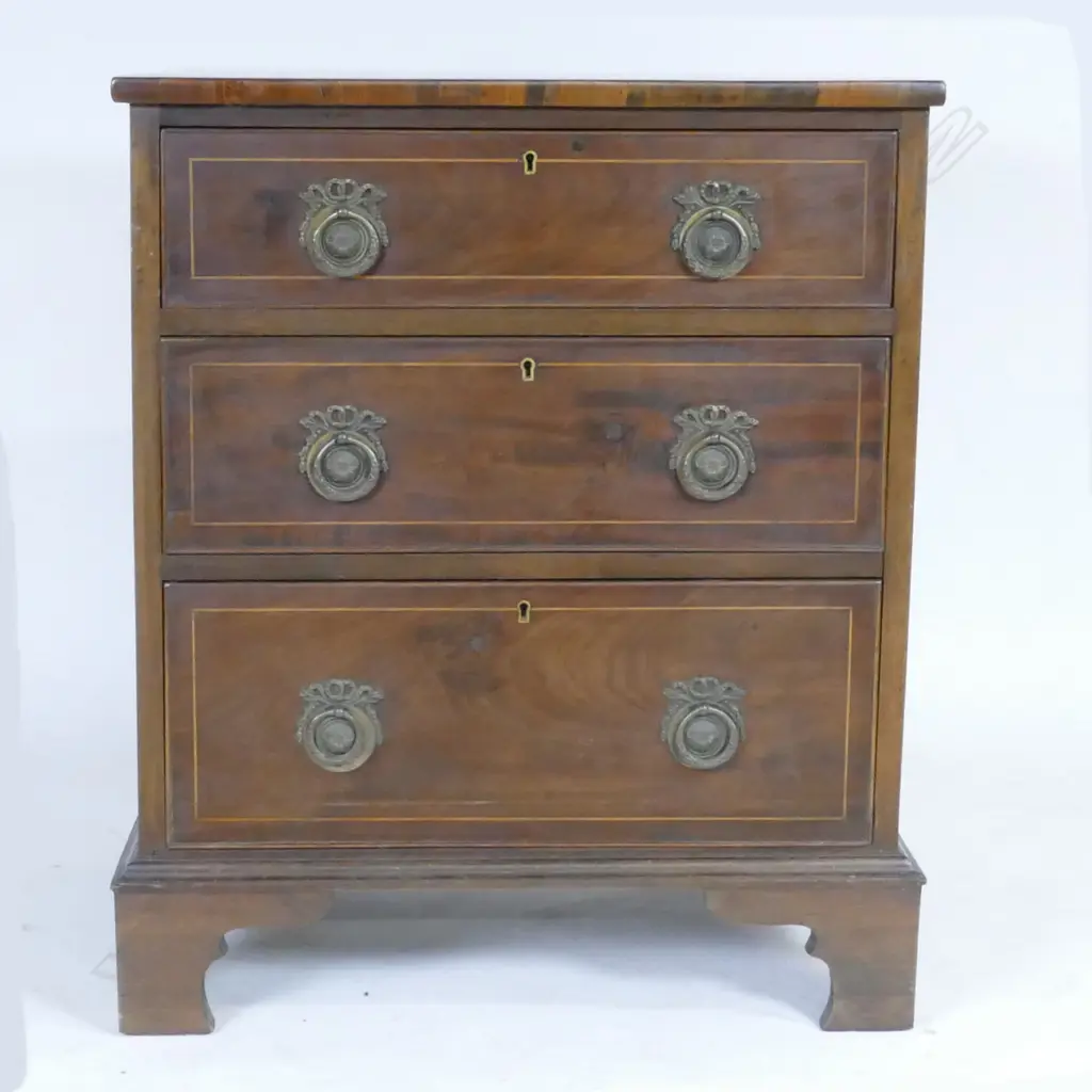 A small proportion Edwardian Sheraton Revival chest of three drawers Image 1++