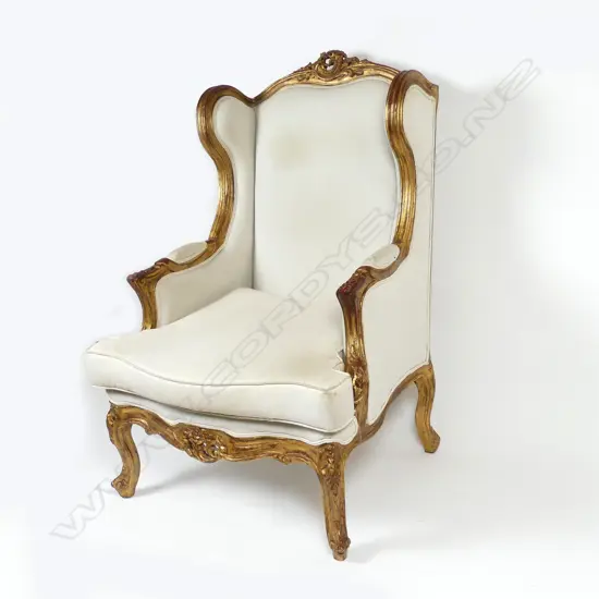 A Louis XVI style gilt wood framed bergère wing back chair