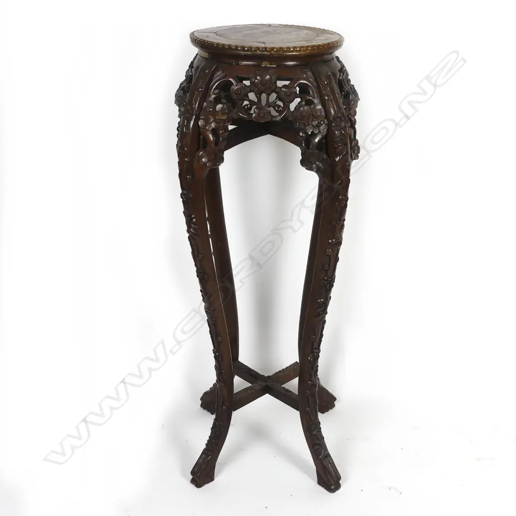 An Oriental carved rosewood torchiere Image 1++