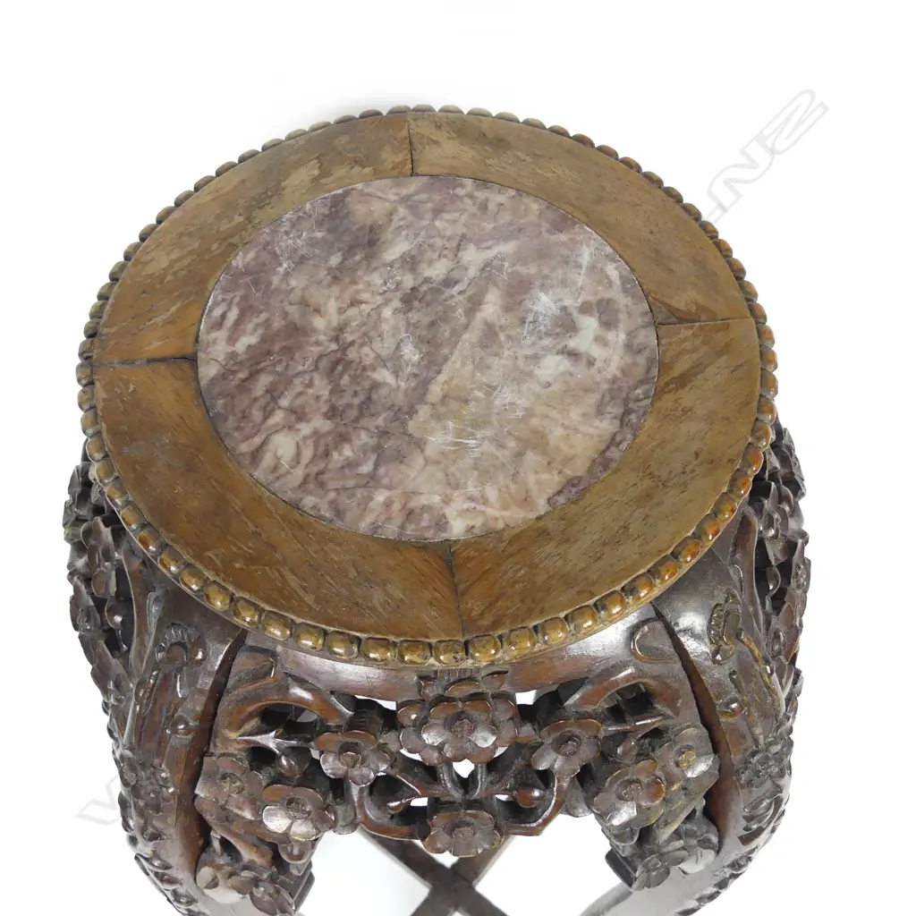 An Oriental carved rosewood torchiere Image 1++