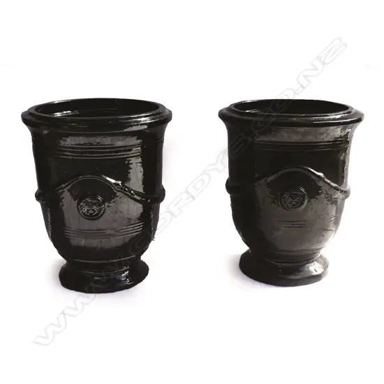 A pair of black glazed French 'Versailles' style garden urns