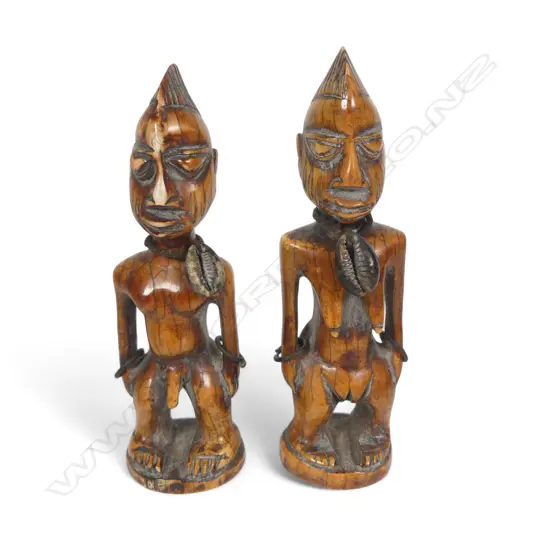 A pair of early 20thC Yoruba carved ivory Ibeji twins,