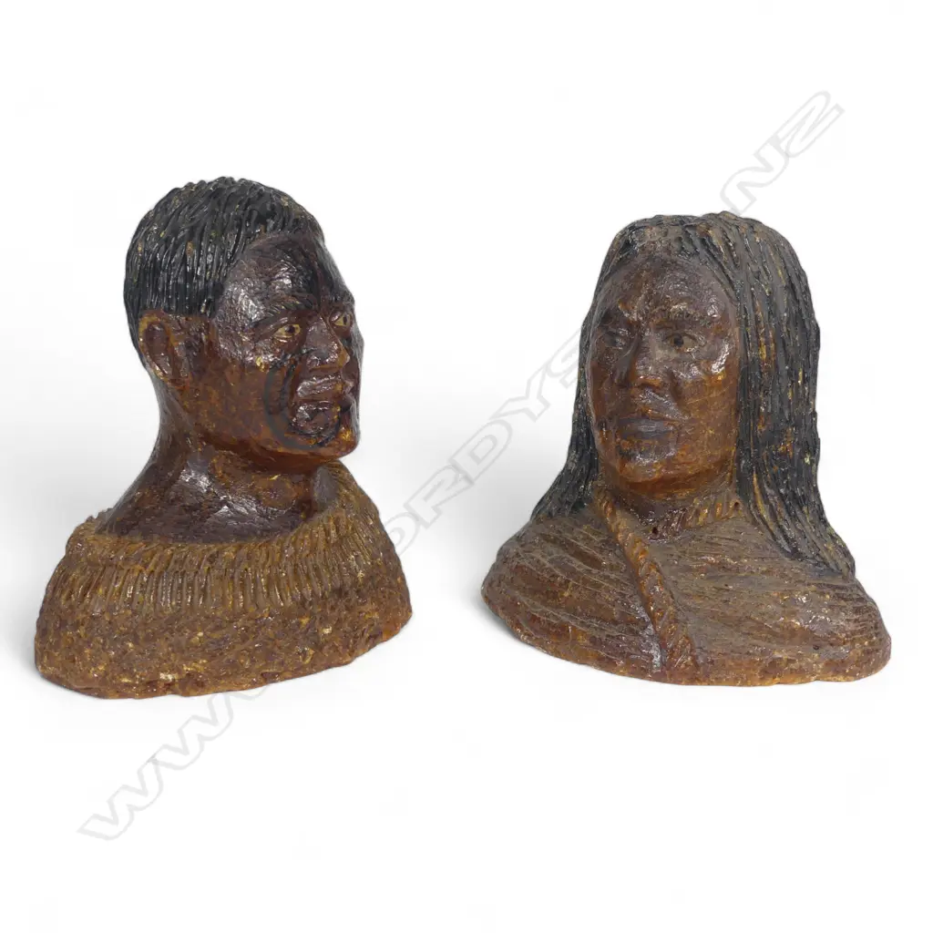 A pair of late 19thC large carved kauri gum busts of a Māori chief and chieftainess, naturalistically represented with black staining to their hair and moko, both represented with a muka cloak wrapped to their shoulders. Minor chipping to edges. H's.105mm. Provenance: From the John Perry estate. Image 1++