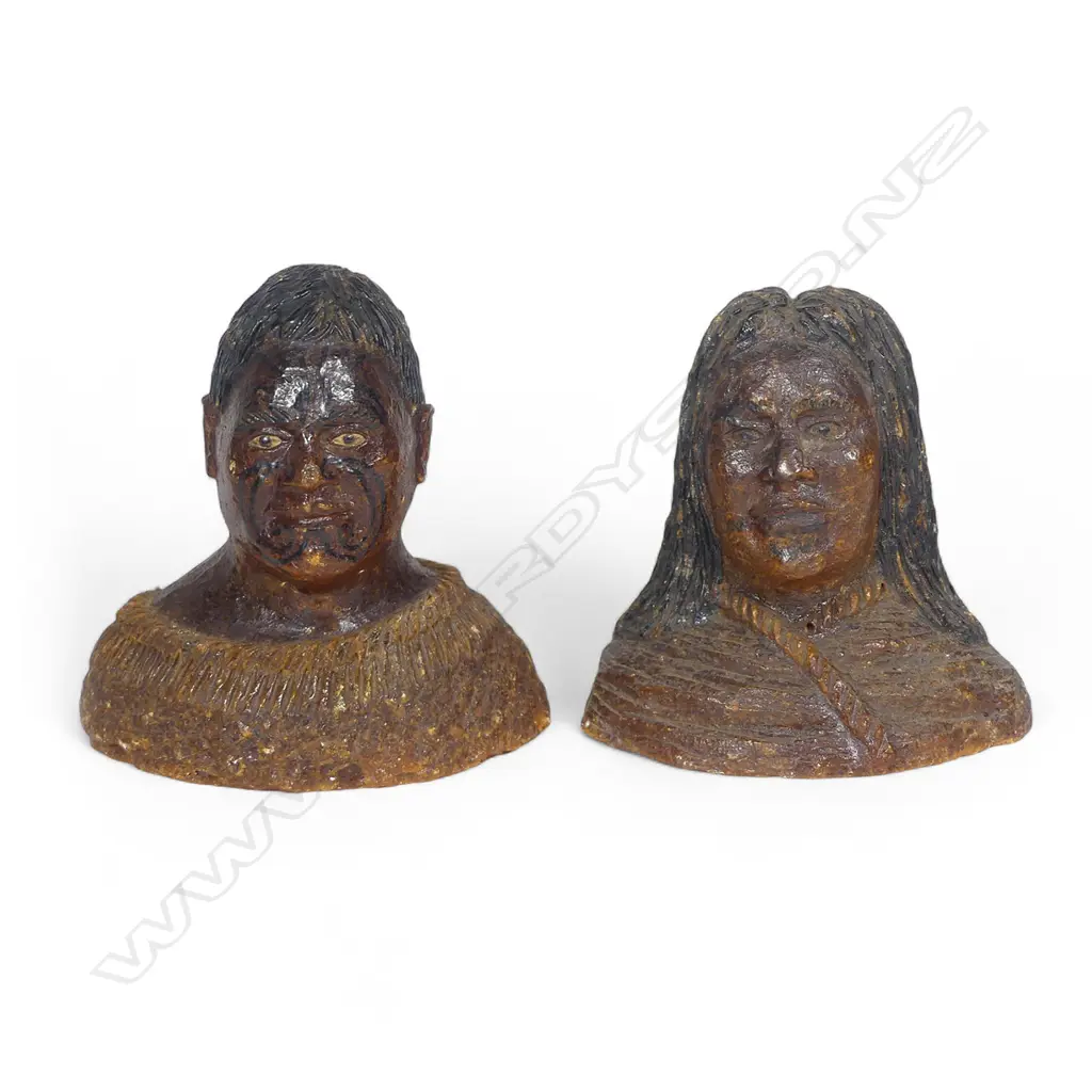 A pair of late 19thC large carved kauri gum busts of a Māori chief and chieftainess, naturalistically represented with black staining to their hair and moko, both represented with a muka cloak wrapped to their shoulders. Minor chipping to edges. H's.105mm. Provenance: From the John Perry estate. Image 1++