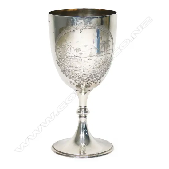 A New Zealand historical silver trophy cup - engraved 'Presented by The New Zealand Loan & Mercantile Agency Company To T.G. Smith, Wells Hill. For Best Pen 5 Merino Ewe Hoggets. Blenheim. 27th Nov. 1889'. Engraved to the front with a colonial mountain and pastoral landscape with sheep and a cow. H.235mm. 308gms