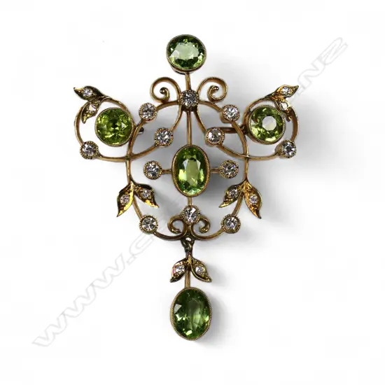 An Edwardian 15ct gold peridot and diamond brooch,