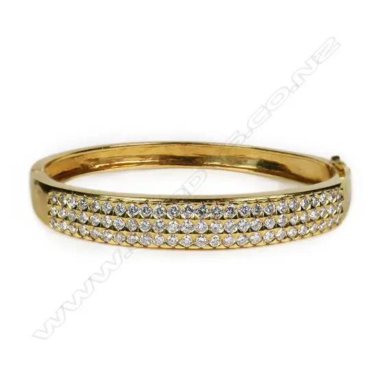 A heavy 18ct gold and diamond hinged bangle,