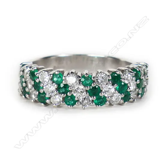 An 18ct white gold emerald and diamond dress ring,