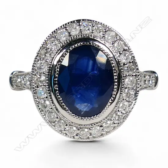 A 14ct white gold sapphire and diamond halo ring,