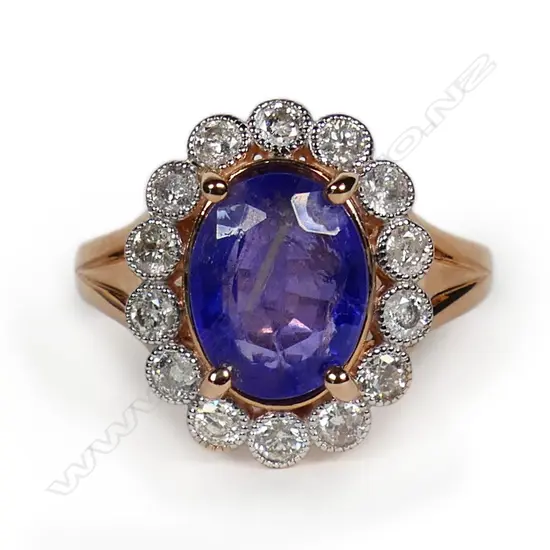 A 14ct rose gold tanzanite and diamond halo ring,