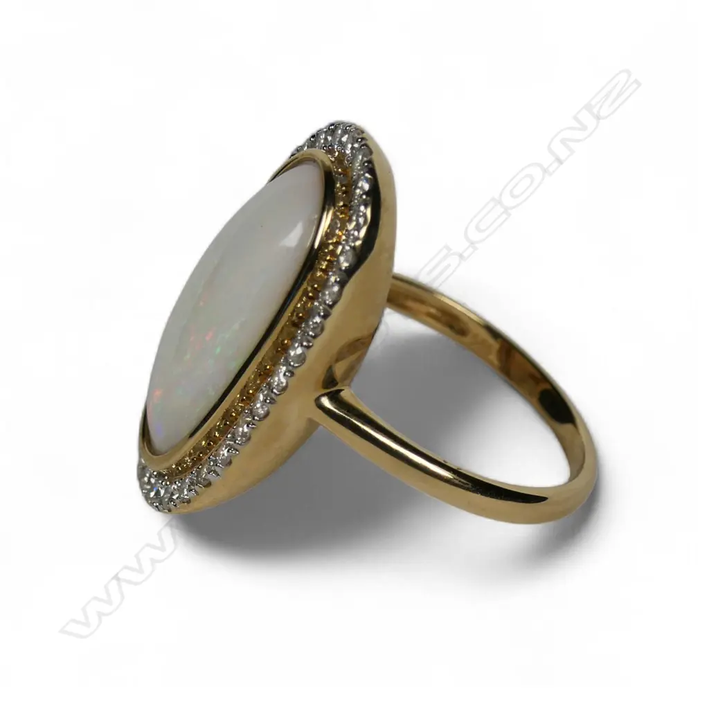 A 14ct gold opal and diamond halo ring, Image 1++