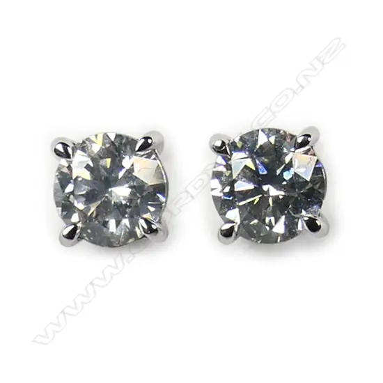 A pair of 14ct white gold and diamond stud earrings,
