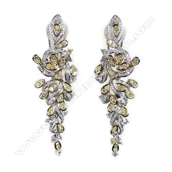 A pair of white and yellow gold diamond earrings,
