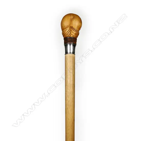 A walking stick with carved handle,
