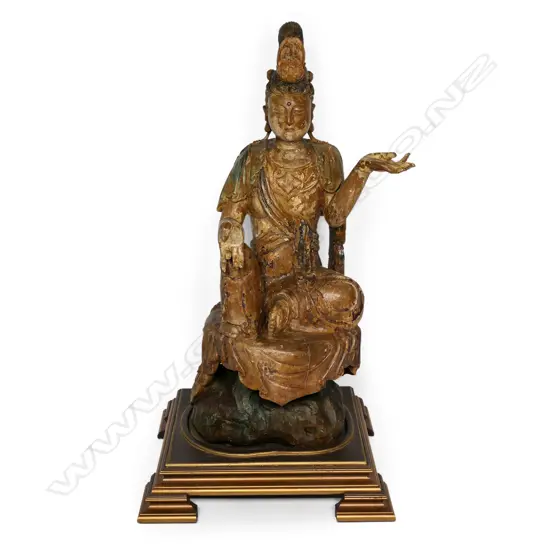 A 19thC wooden statue of Guan Yin,