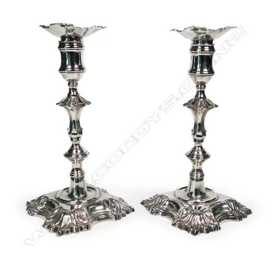 A pair of rare George II heavy cast silver candlesticks,
