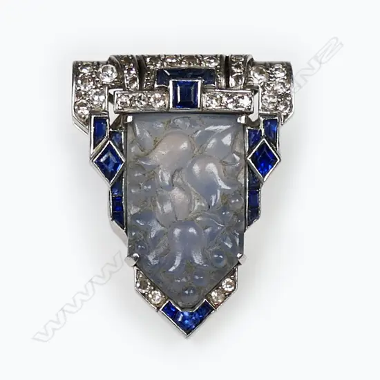 A quality Art Deco 18ct white gold carved hardstone sapphire and diamond dress clip,