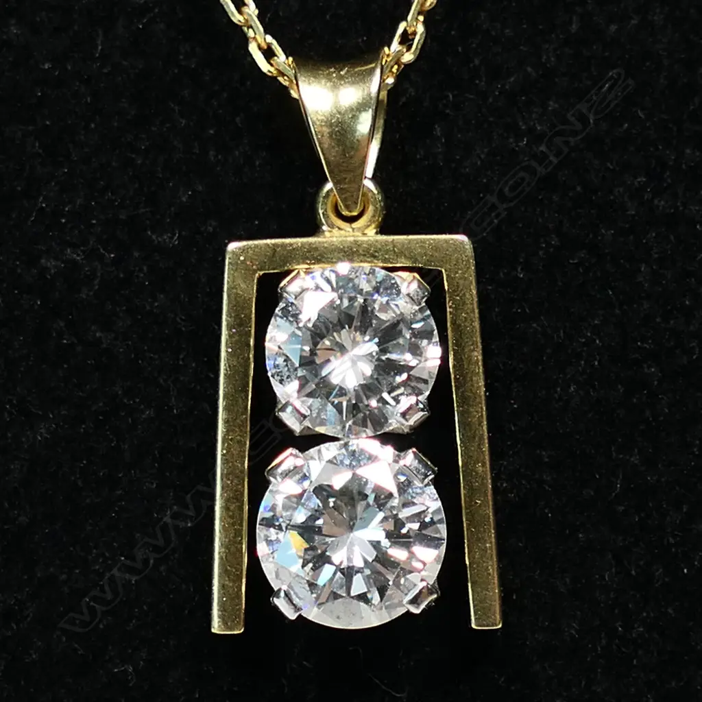 A retro 18ct gold and diamond pendant - a 1.56ct round brilliant cut diamond (Colour I, Clarity I), together with a 1.14ct round brilliant cut diamond (Colour J, Clarity VVS), claw set vertically in white gold, between a yellow gold frame, suspension bale and with fine 18ct gold chain. TDW. 2.70ct. Replacement valuation of $72,500.00. Image 1++