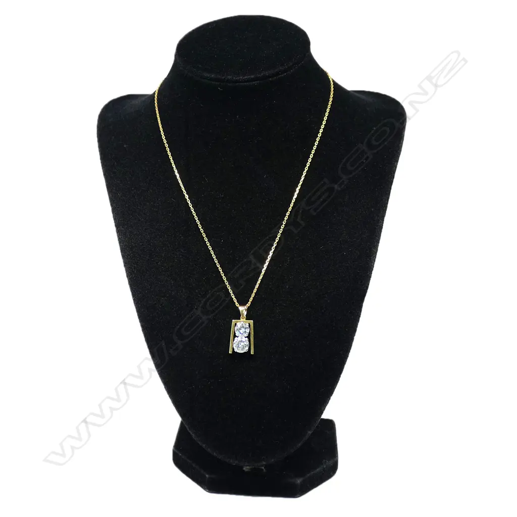 A retro 18ct gold and diamond pendant - a 1.56ct round brilliant cut diamond (Colour I, Clarity I), together with a 1.14ct round brilliant cut diamond (Colour J, Clarity VVS), claw set vertically in white gold, between a yellow gold frame, suspension bale and with fine 18ct gold chain. TDW. 2.70ct. Replacement valuation of $72,500.00. Image 1++