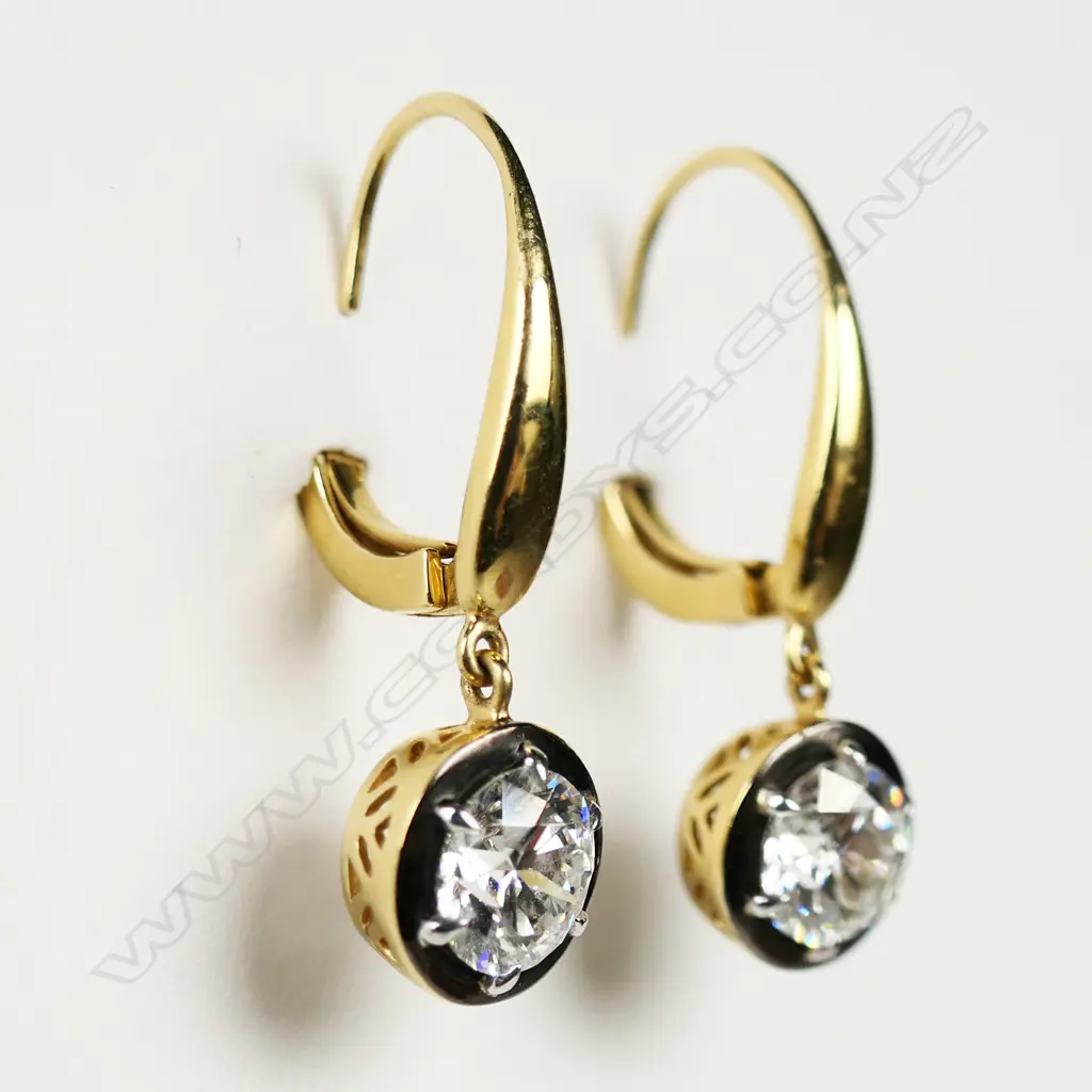 A pair of 18ct gold and diamond earrings, Image 1++