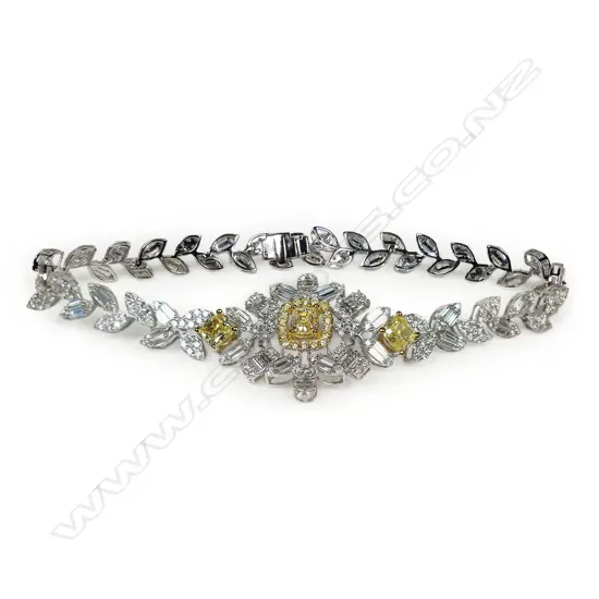 An 18ct white gold and white and yellow diamond bracelet,
