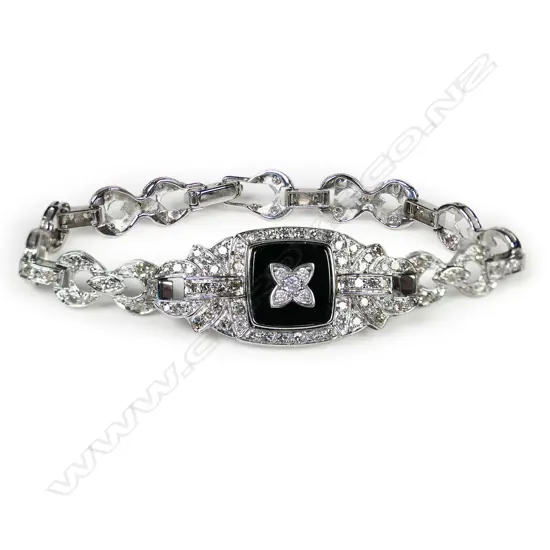 A 14ct white gold diamond and onyx Art Deco style bracelet,