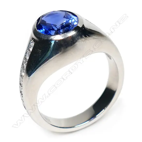 A bespoke Julian Bartrom platinum sapphire and diamond ring,