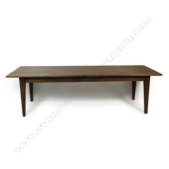 An oak French provincial-style dining table,