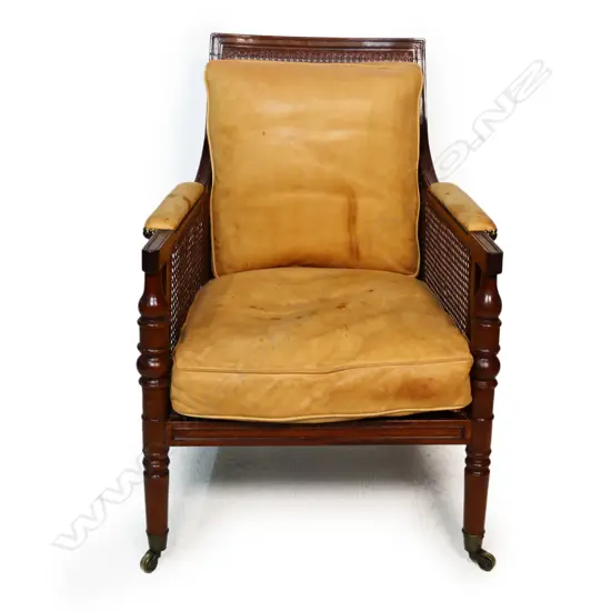 A vintage 20thC Regency style mahogany and leather Bergère chair,