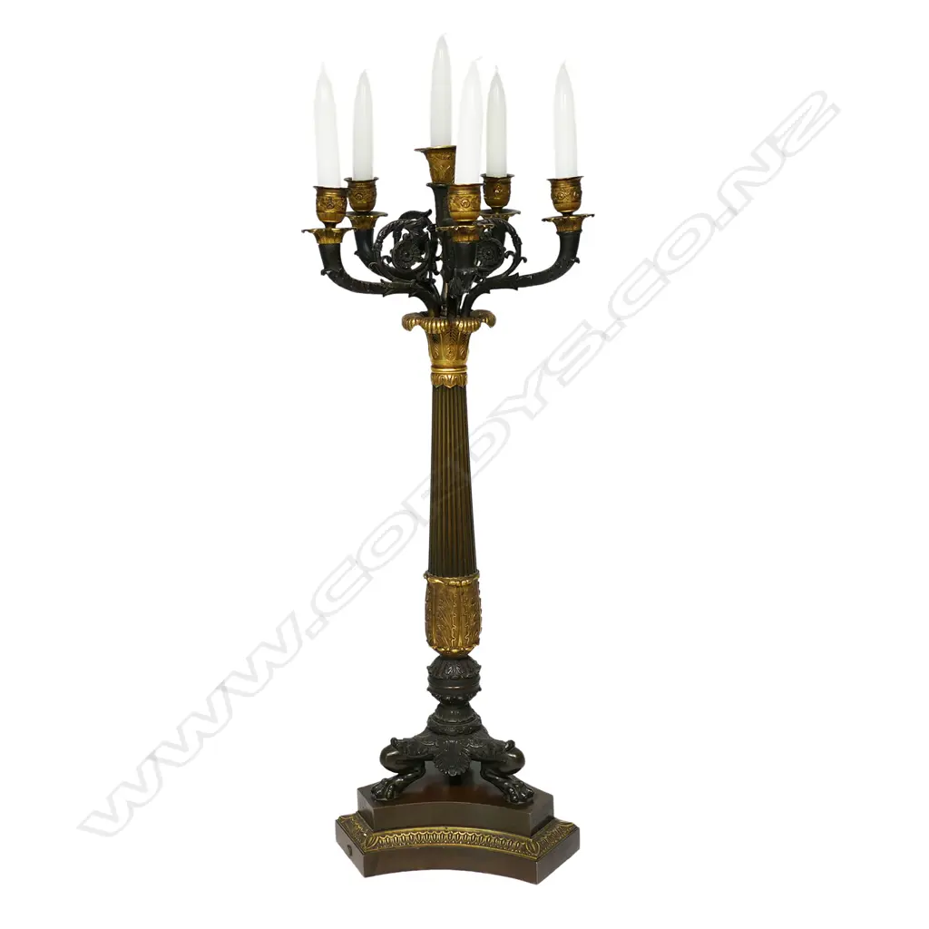A quality 19thC Napoleon III Empire bronze table candelabra - gilt and patinated highlights to the four scrolling arms and five nozzles, acanthus leaf detail, raised on three lion's paw and leg feet, with conforming platform base. H.705mm. Image 1++