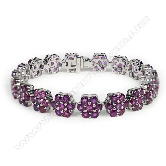 A 14ct white gold and ruby floral design bracelet,