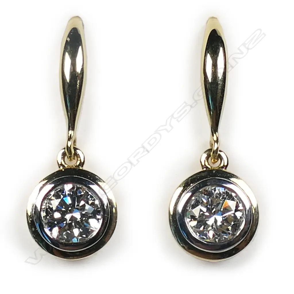 A pair of 18ct yellow gold and diamond solitaire earrings, Image 1++
