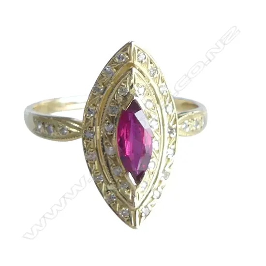 A 18ct gold ruby and diamond ring the marquis cut bright red ruby bar set at each end and surrounded by two curved marquis shaped diamond set halos three single cut diamonds to each shoulder.