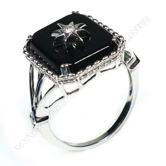 A 14ct white gold black onyx and diamond Art Deco style ring,