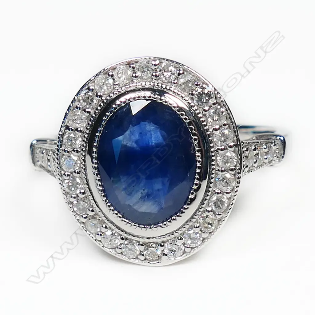 A 14ct white gold sapphire and diamond halo ring, Image 1++