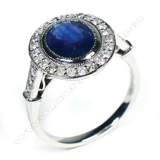 A 14ct white gold sapphire and diamond halo ring,