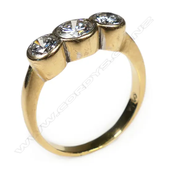 An 18ct gold and three stone diamond ring,