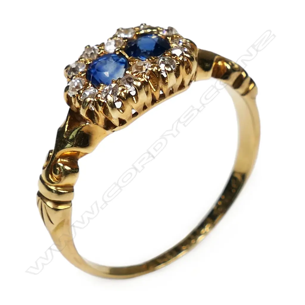 An 18ct yellow gold two sapphire and diamond cluster ring, Image 1++