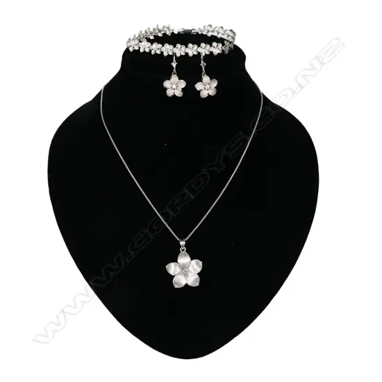 A white gold and diamond floral design jewellery suite',