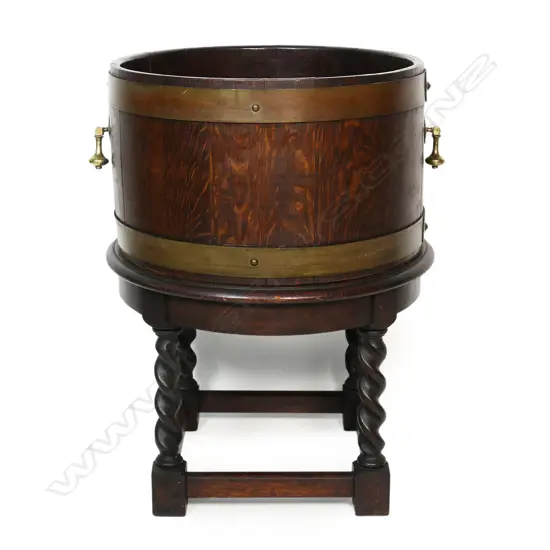An oak barrel form planter on stand,