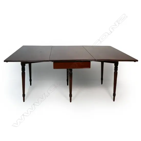 A late Georgian mahogany drop leave D-end dining table,