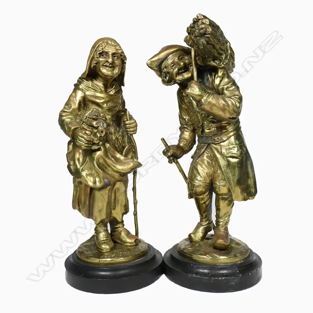 A pair of 19thC gilt bronze statuettes of a man and woman carrying bundles of faggots - each eldery character in patched and repaired attire, he wears a bicorn hat. Both on circular black slate bases. Unsigned. H.310mm, Image 1++