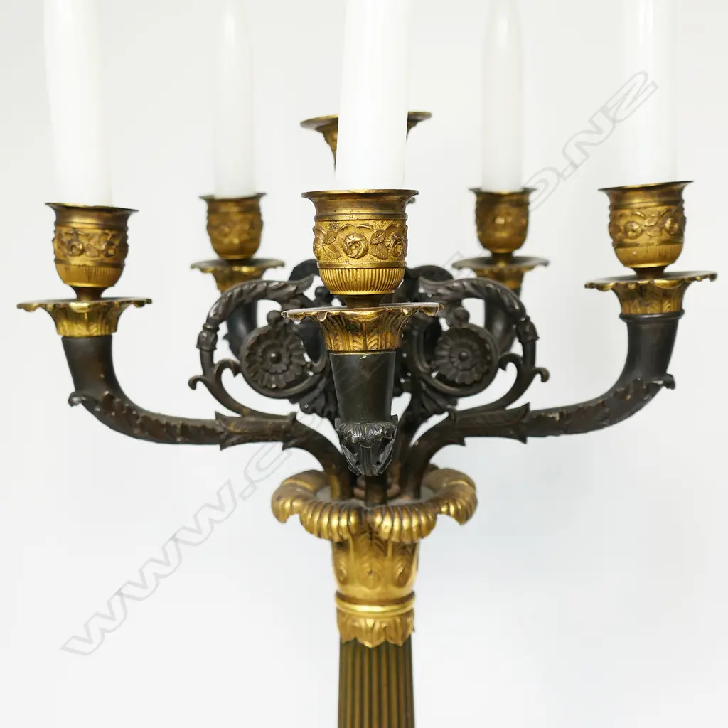 A quality 19thC Napoleon III Empire bronze table candelabra - gilt and patinated highlights to the four scrolling arms and five nozzles, acanthus leaf detail, raised on three lion's paw and leg feet, with conforming platform base. H.705mm. Image 1++
