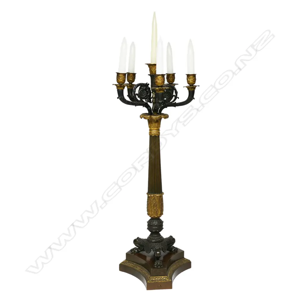 A quality 19thC Napoleon III Empire bronze table candelabra - gilt and patinated highlights to the four scrolling arms and five nozzles, acanthus leaf detail, raised on three lion's paw and leg feet, with conforming platform base. H.705mm. Image 1++