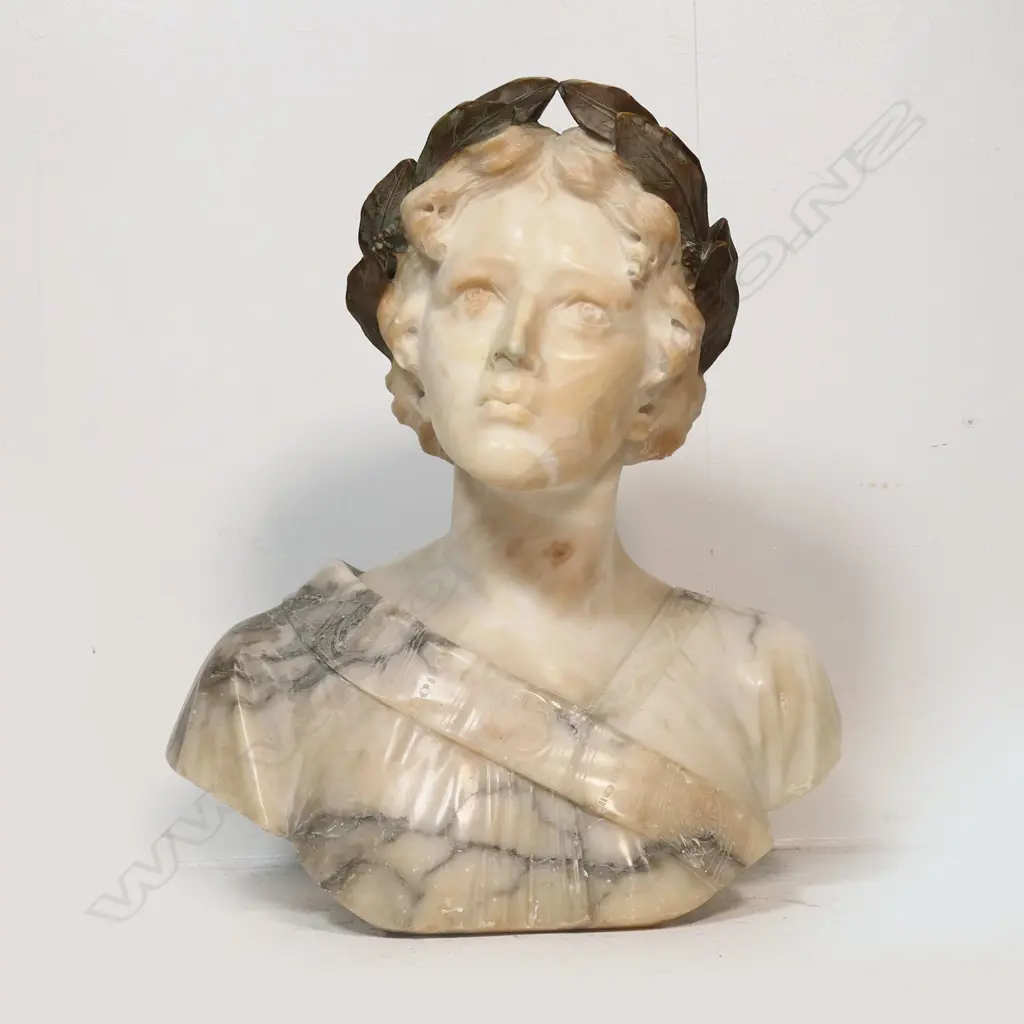 A large carved marble bust of a woman - with laurel wreath about her head, looking upwards, signed Giussepe Bess. Professional repair to nose. H.550mm. Image 1++