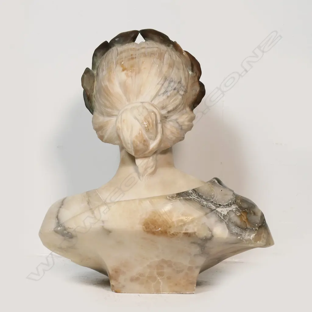 A large carved marble bust of a woman - with laurel wreath about her head, looking upwards, signed Giussepe Bess. Professional repair to nose. H.550mm. Image 1++