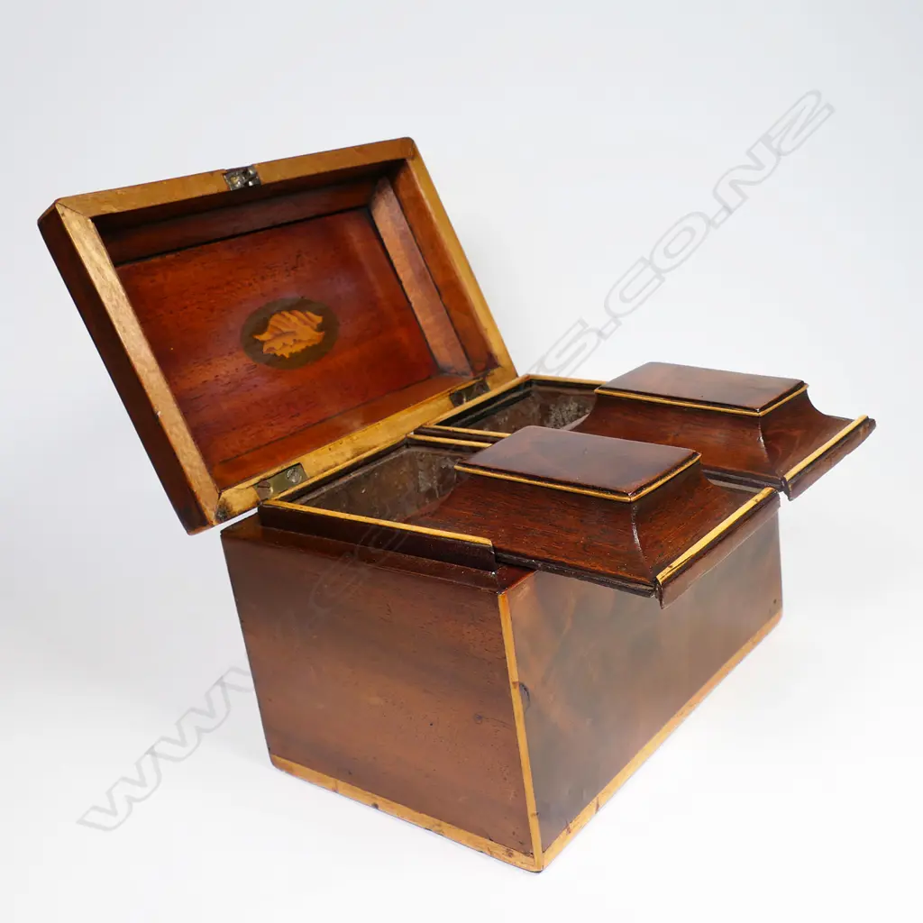 A 19thC small proportioned, flame mahogany veneered, sarcophagus lidded tea caddy - Opening to reveal two sarcophagi sliding lidded, removeable canisters, with pale timber stringing. With key.170 x 115 x 130mm. Image 1++