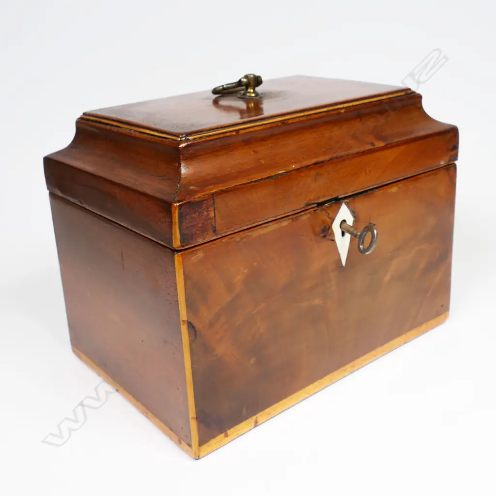 A 19thC small proportioned, flame mahogany veneered, sarcophagus lidded tea caddy - Opening to reveal two sarcophagi sliding lidded, removeable canisters, with pale timber stringing. With key.170 x 115 x 130mm. Image 1++